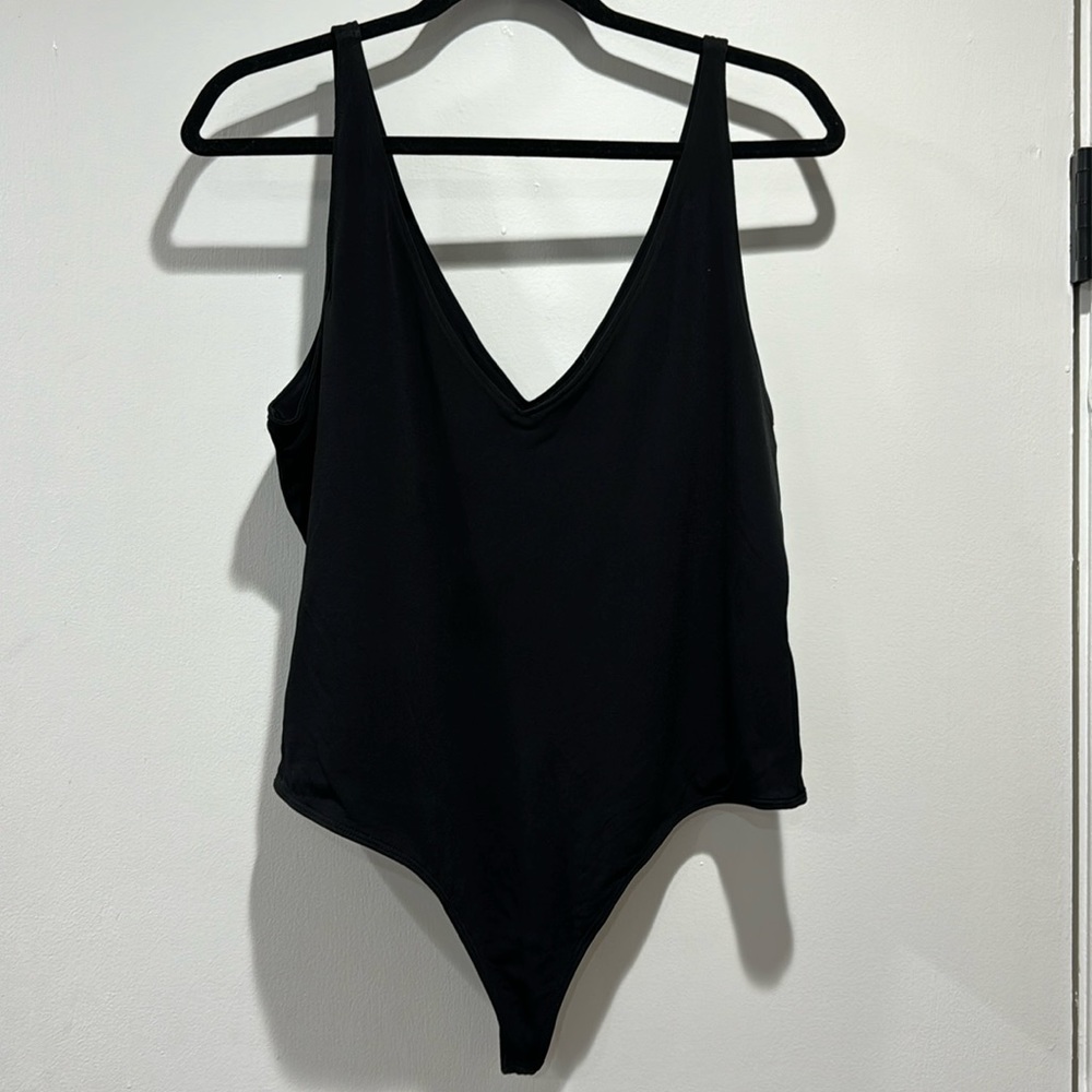 Black thong bodysuit. Deep V.